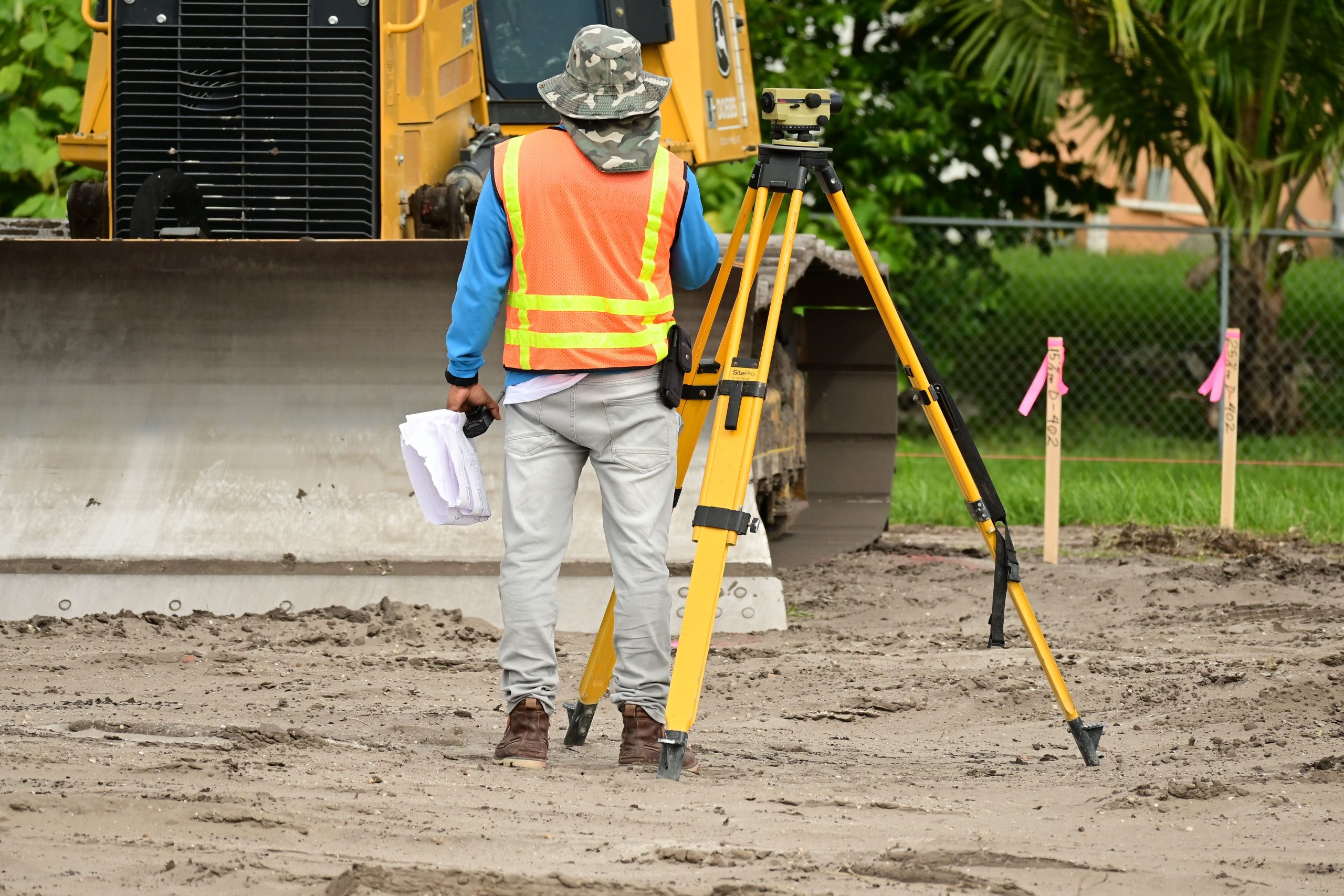 Géomètre effectue mesures sur chantier